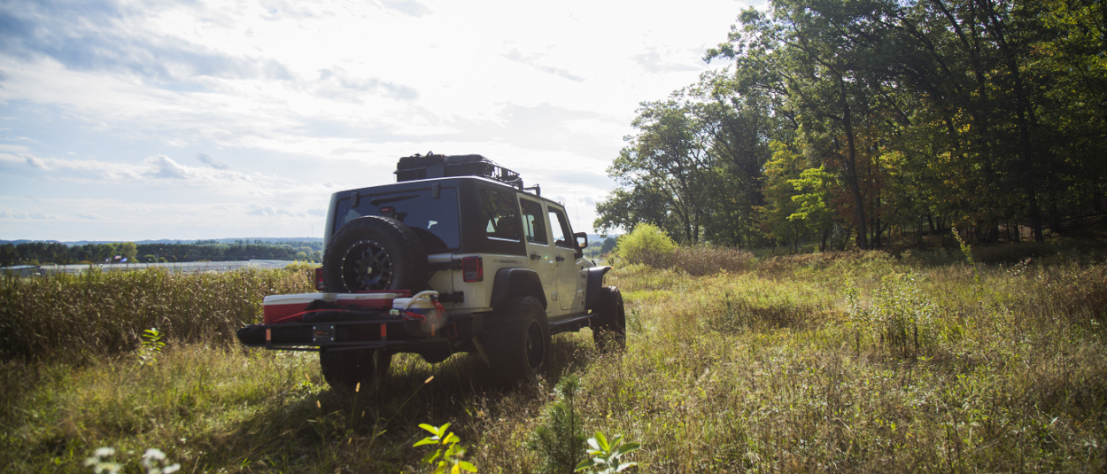 CURT trailer hitch - Jeep Cherokee towing camper CURT hitch cargo carrier and rooftop cargo carrier on Jeep