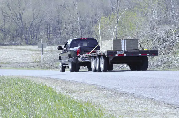 Dually Truck Towing Heavy-Duty Flatbed Trailer Dually Truck Towing Heavy-Duty Flatbed Trailer