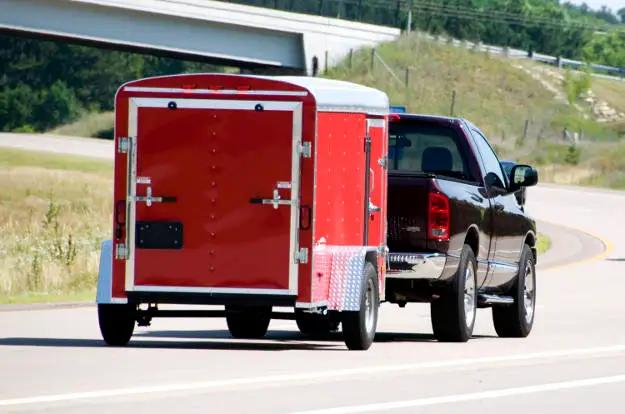 Truck Pulling Enclosed Utility Trailer Truck Pulling Enclosed Utility Trailer
